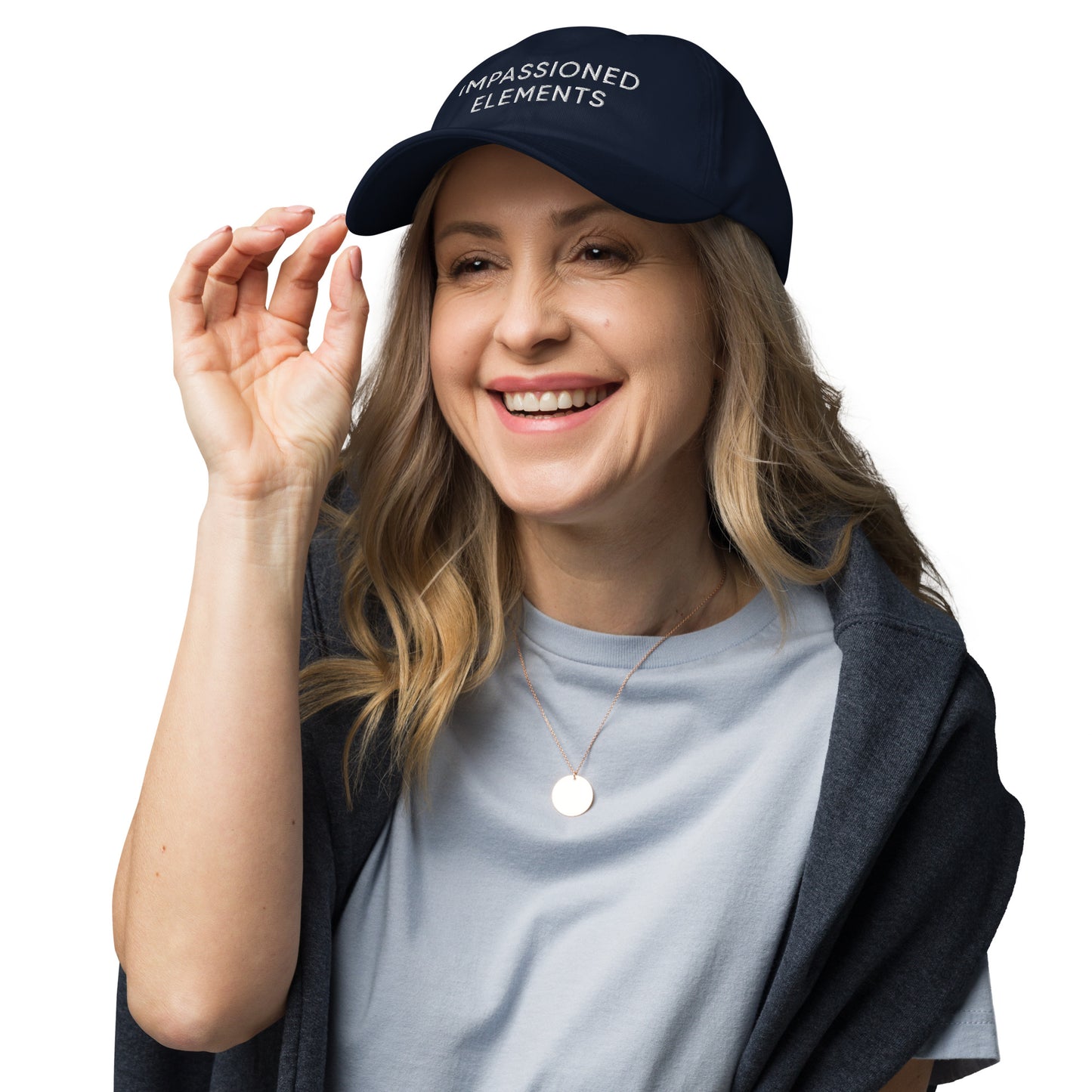 Radiant female model with a smile, wearing the Impassioned Elements unstructured dad hat in navy blue