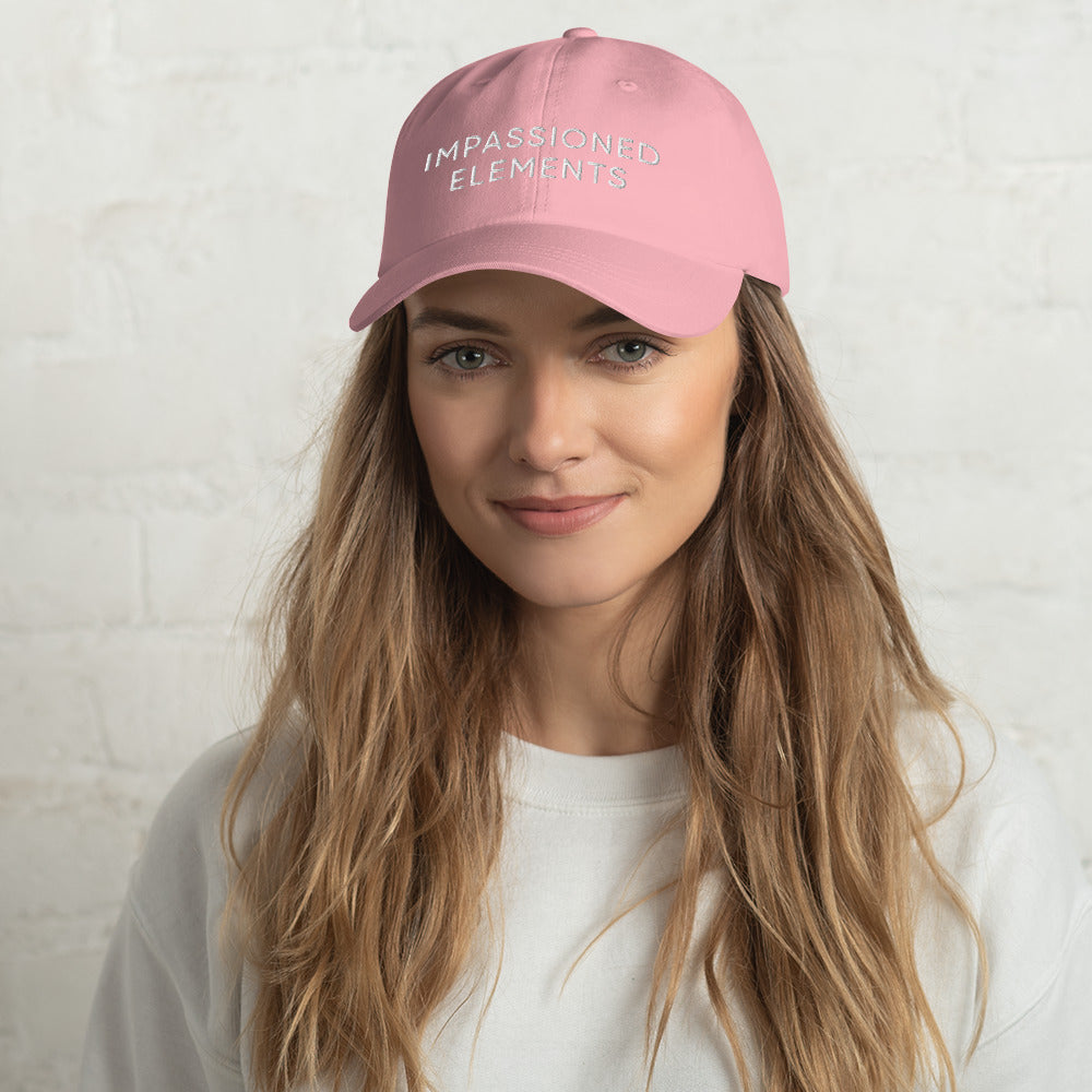 Glowing female model smiling with a pink Impassioned Elements cap on