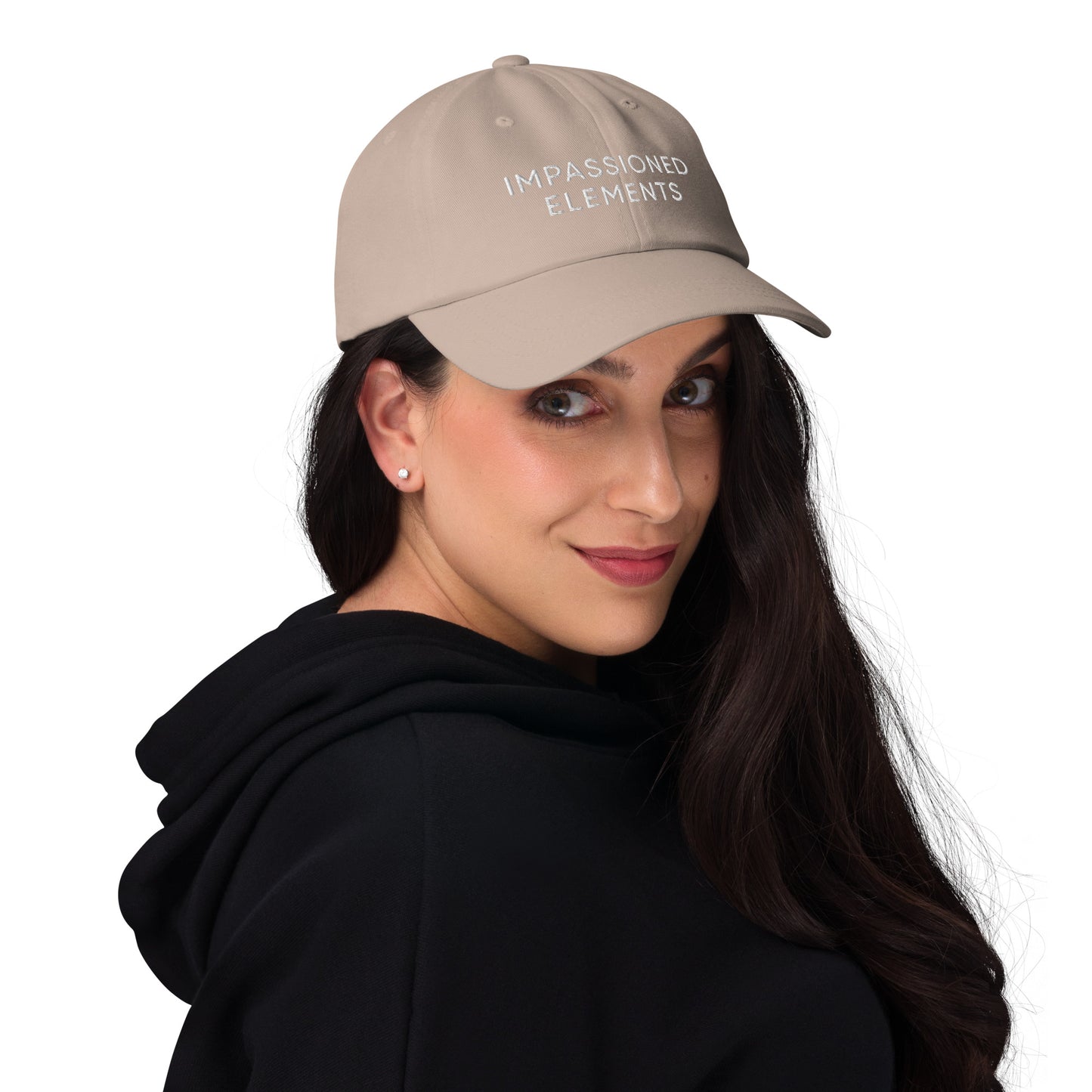 Joyful female model wearing the Impassioned Elements unstructured dad hat in stone color