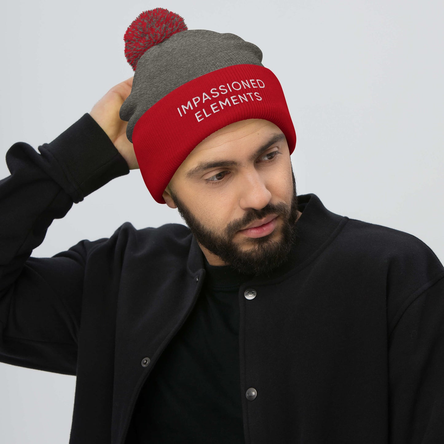 Dark heather grey with red front cuffed beanie effortlessly paired with black attire