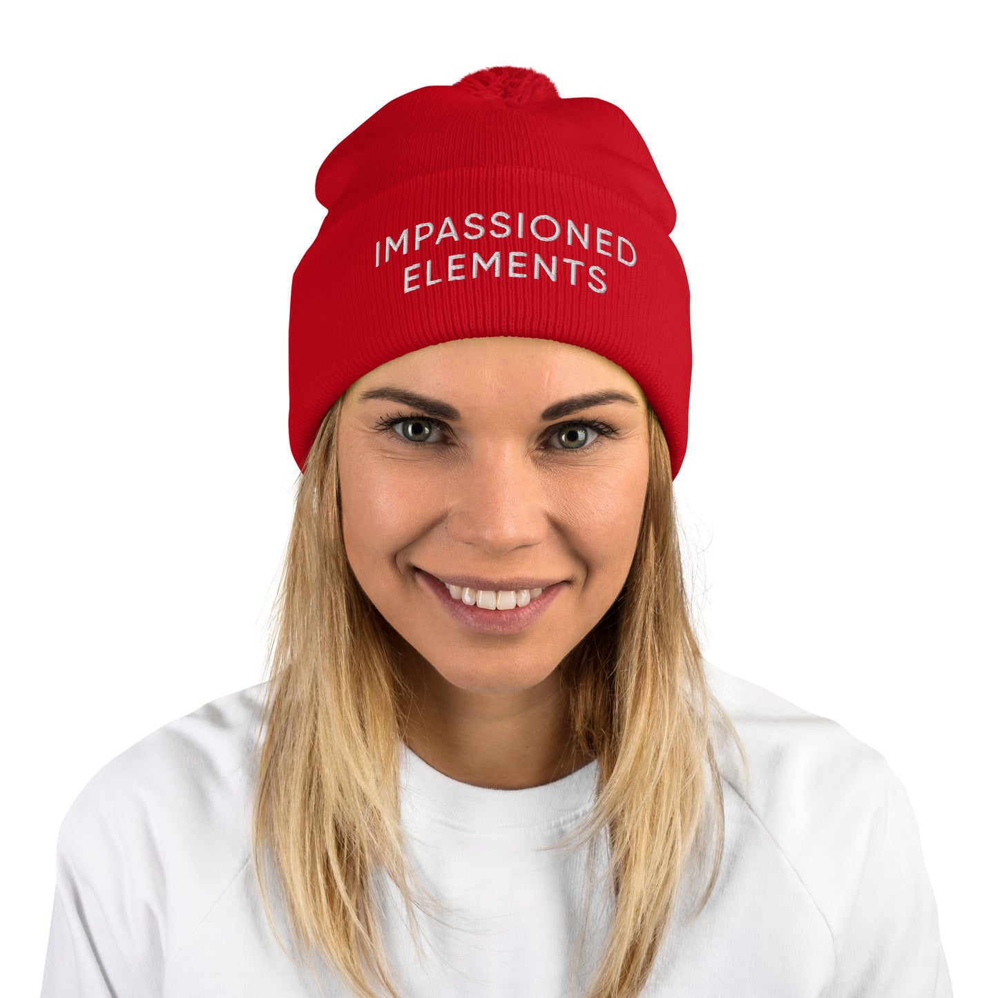 Vibrant female with a red cuffed Impassioned Elements pom-pom knit beanie hat