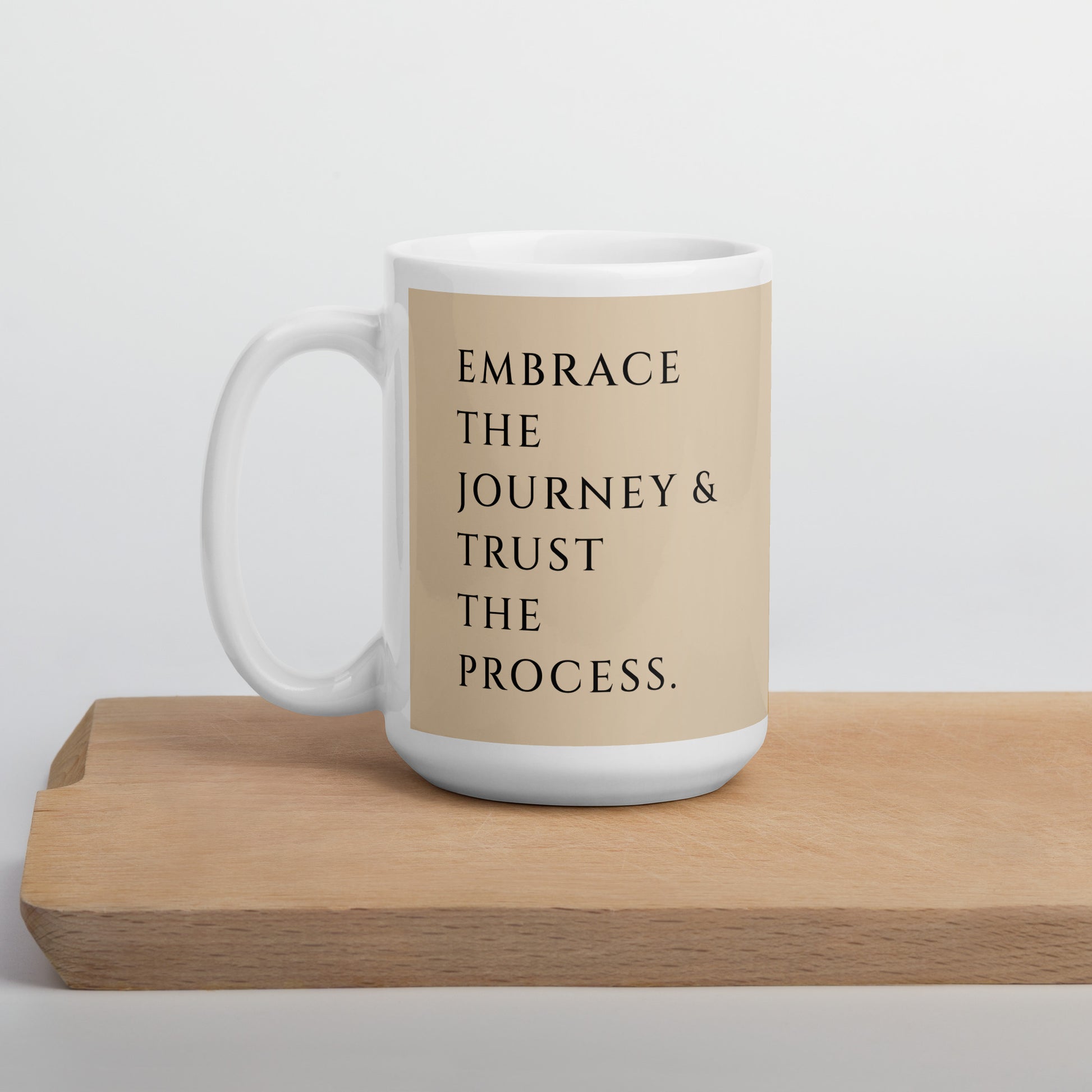 Embrace the journey and trust the process 15 oz mug nicely displayed on kitchen wood block