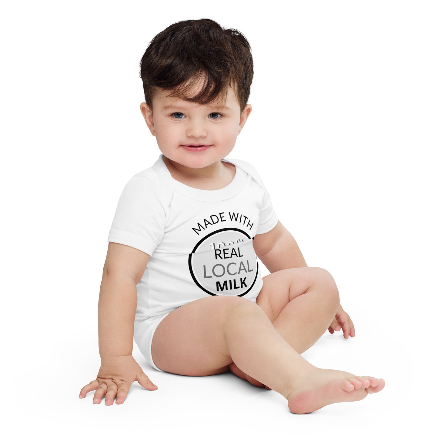 A cute baby wearing a shirt that says, "Made with 100% Real Local Milk." Pure, wholesome goodness for your little one.