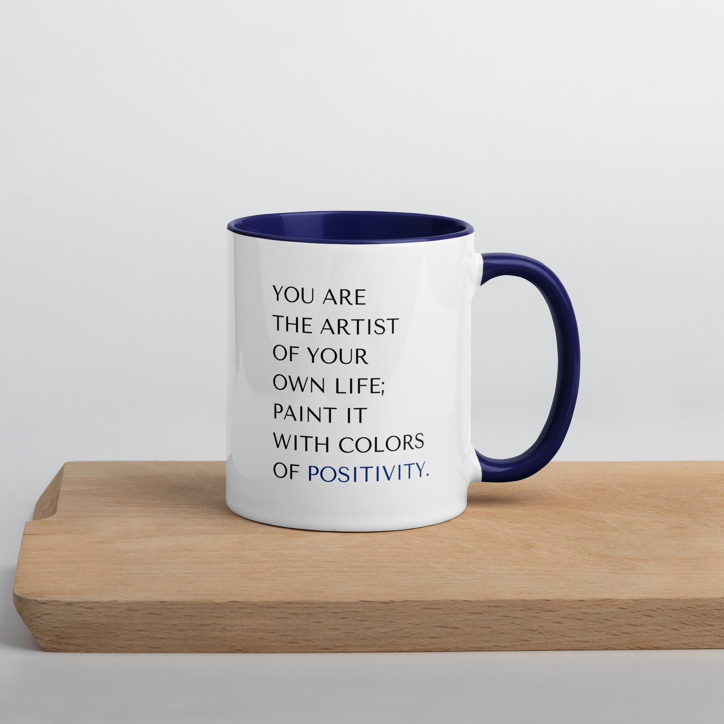 Vibrant white ceramic 11 oz mental health positivity mug with blue handle and inside coloring