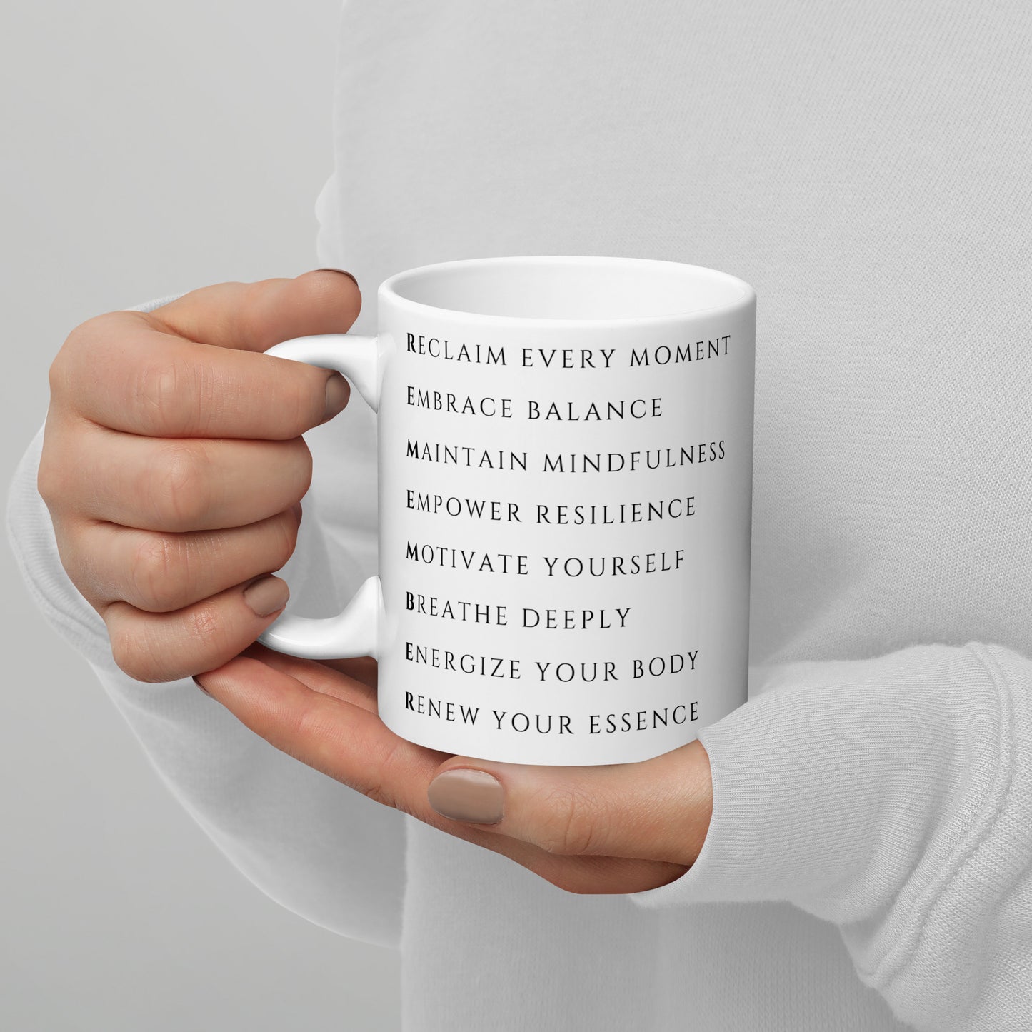 Woman holding an empower resilience reclaim every moment 11 oz ceramic mug