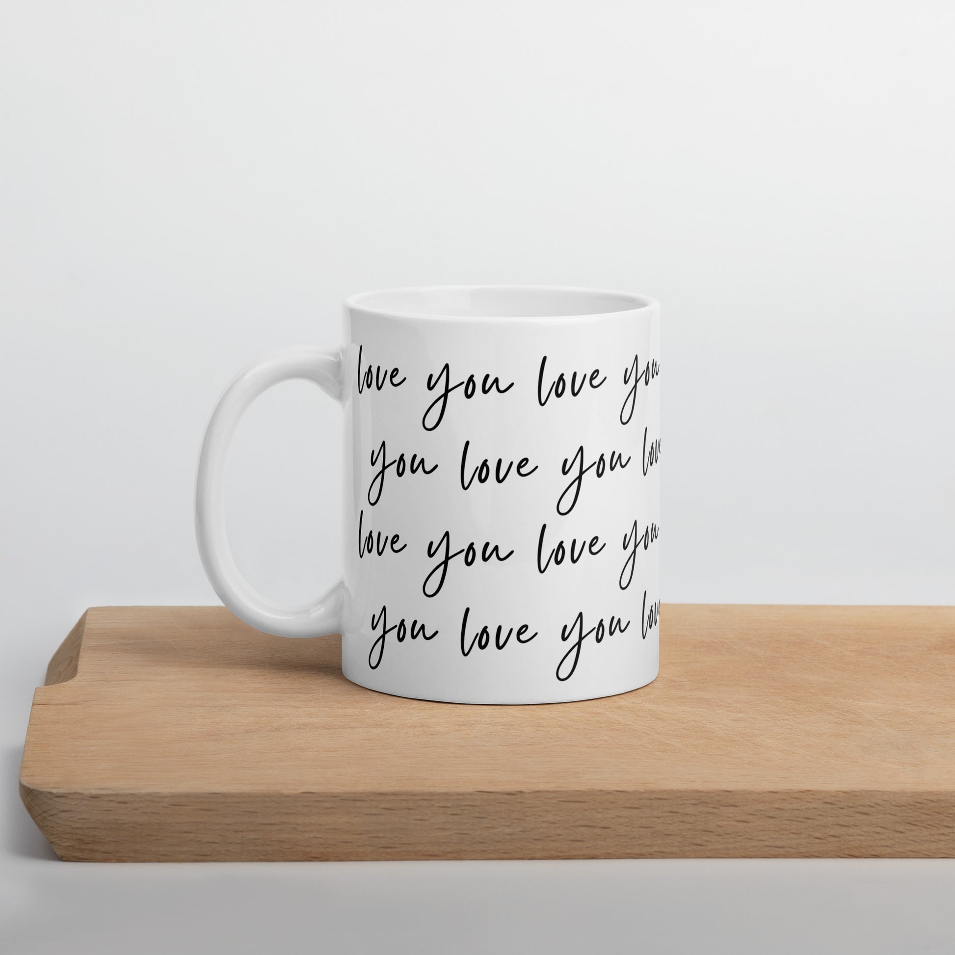 love you 11 oz white ceramic mug on cutting board