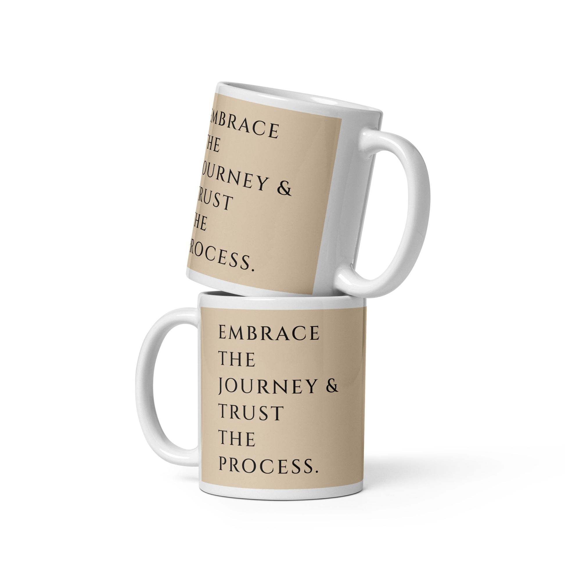 Nicely displayed stacked mugs that read embrace the journey and trust the process to uplift your spirit