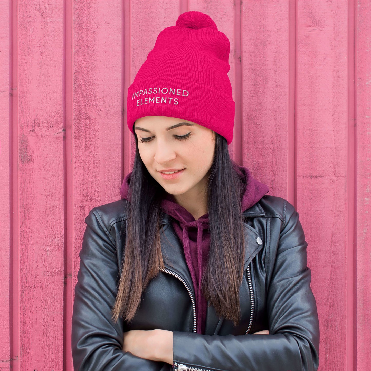 Fashion-forward female in a neon pink Impassioned Elements pom-pom beanie, embracing style