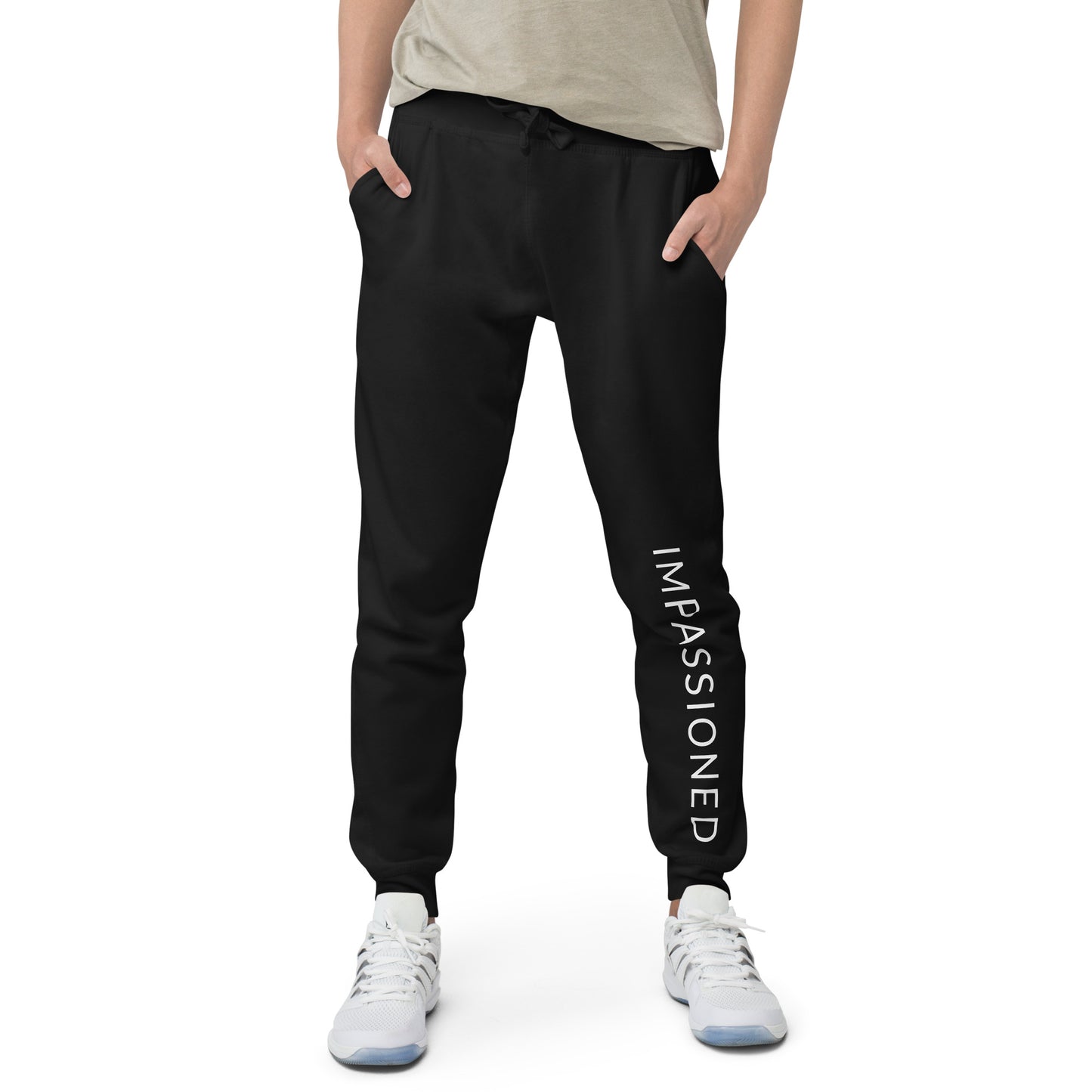 Our Impassioned black unisex jogger sweats worn by a model with hands in front pockets