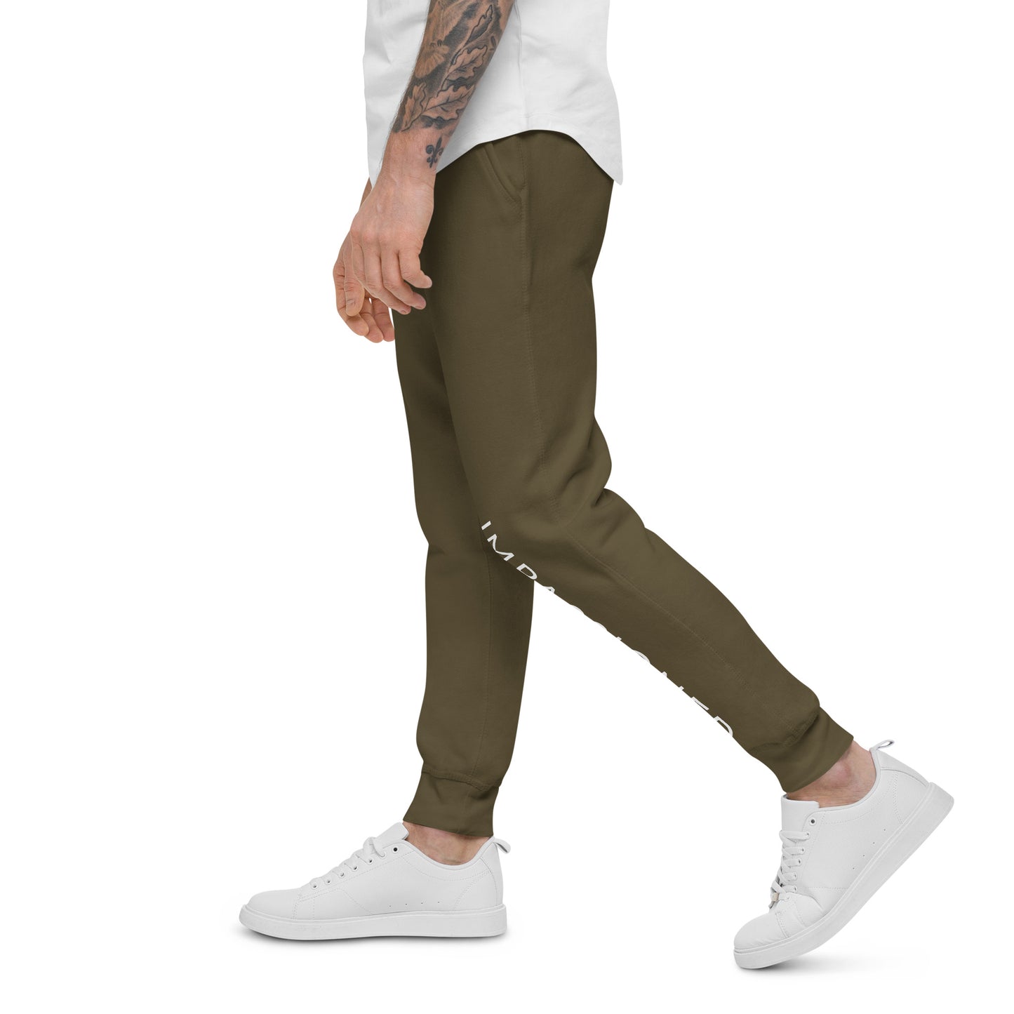 Designed for comfort and style, a male model is showing ease of movement in our military green slim fit sweatpant joggers