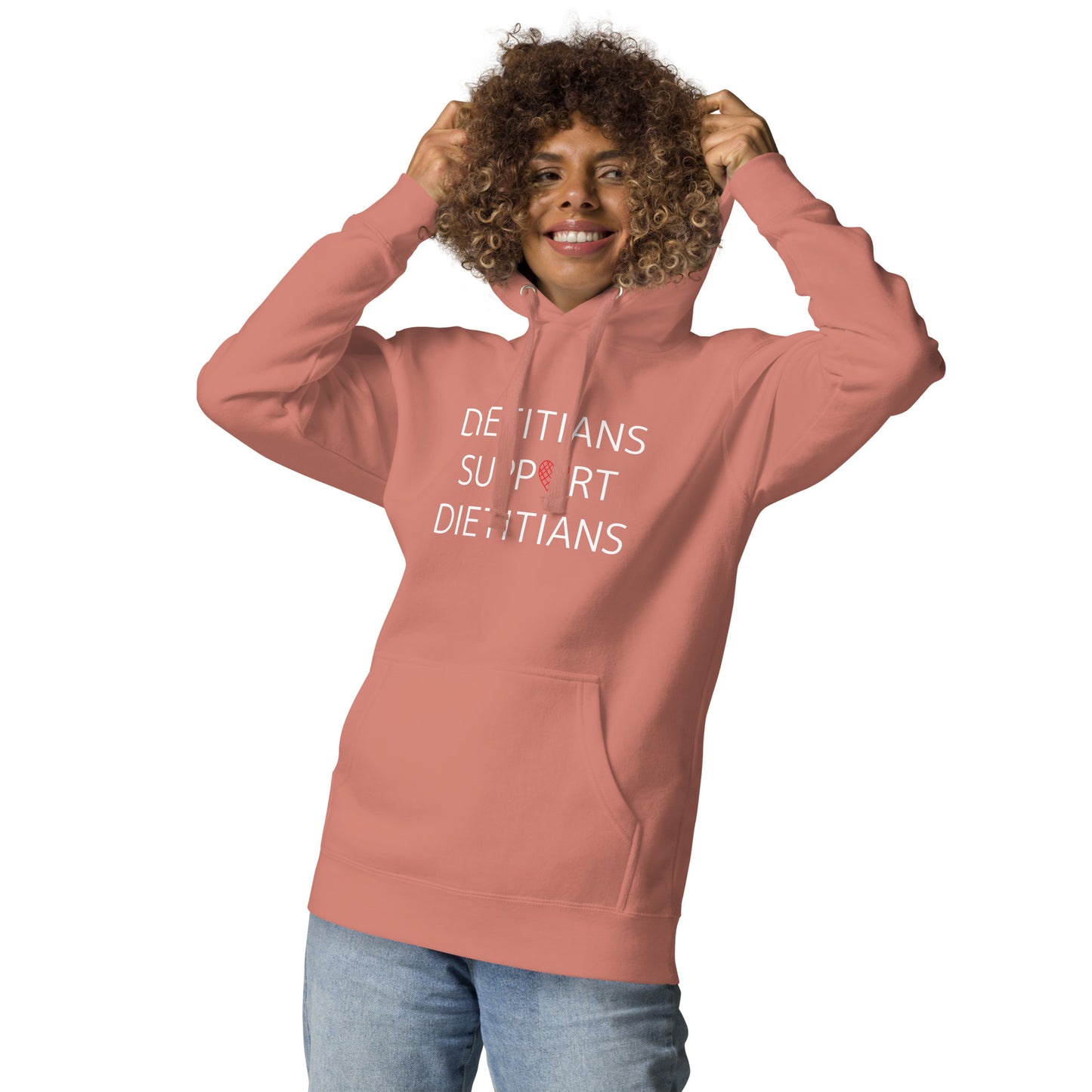 Enthusiastic female model wearing the dusty rose Dietitians Support Dietitians Hoodie with a pair of blue jeans for a casual look