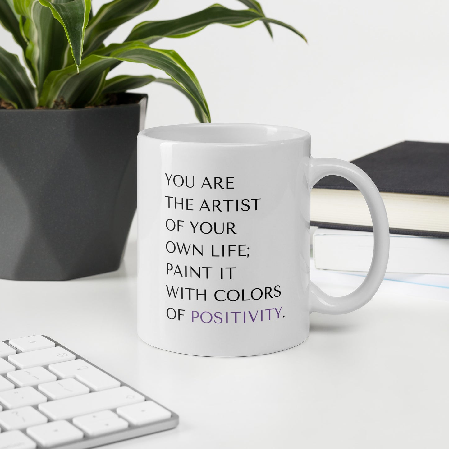 Office setup with 11 oz You are the artist of your own life mug in front of a keyboard