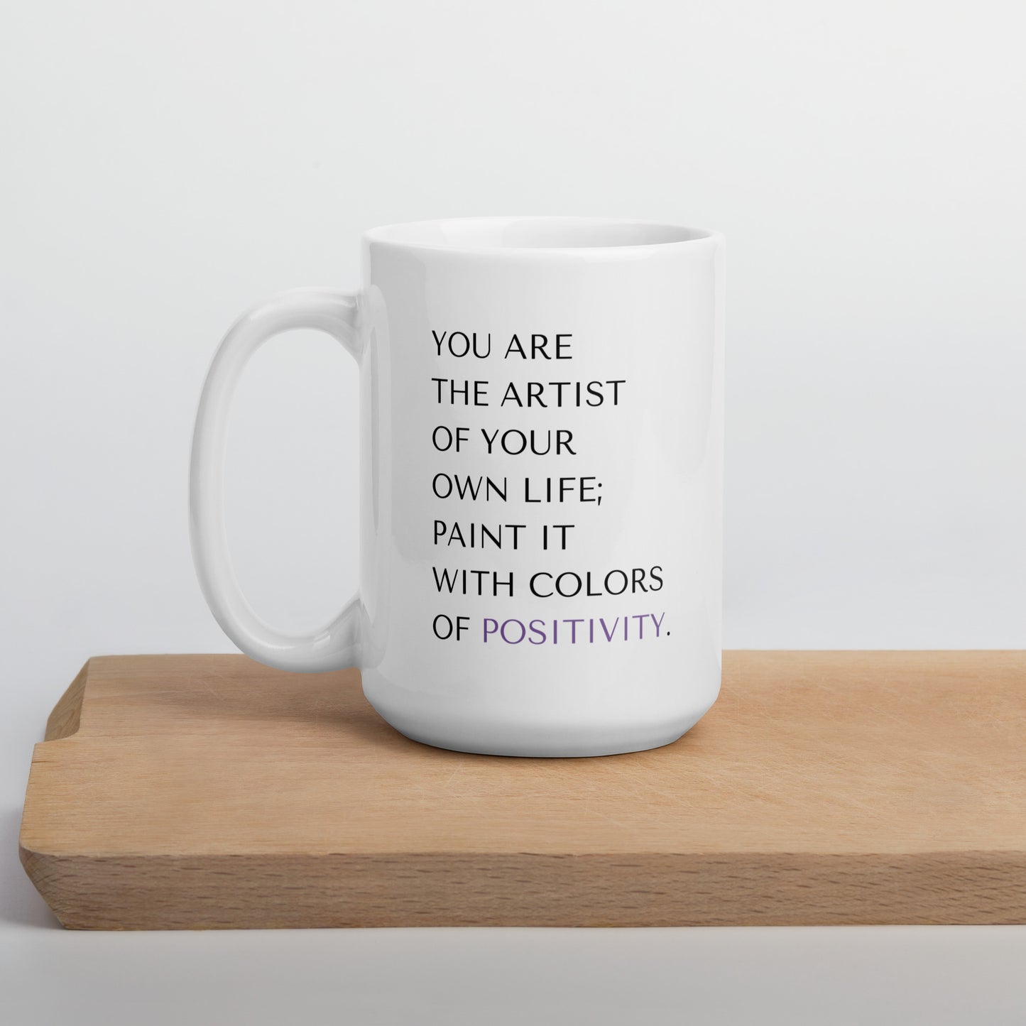 15 oz colors of positivity mug sleekly displayed on a wood serving board