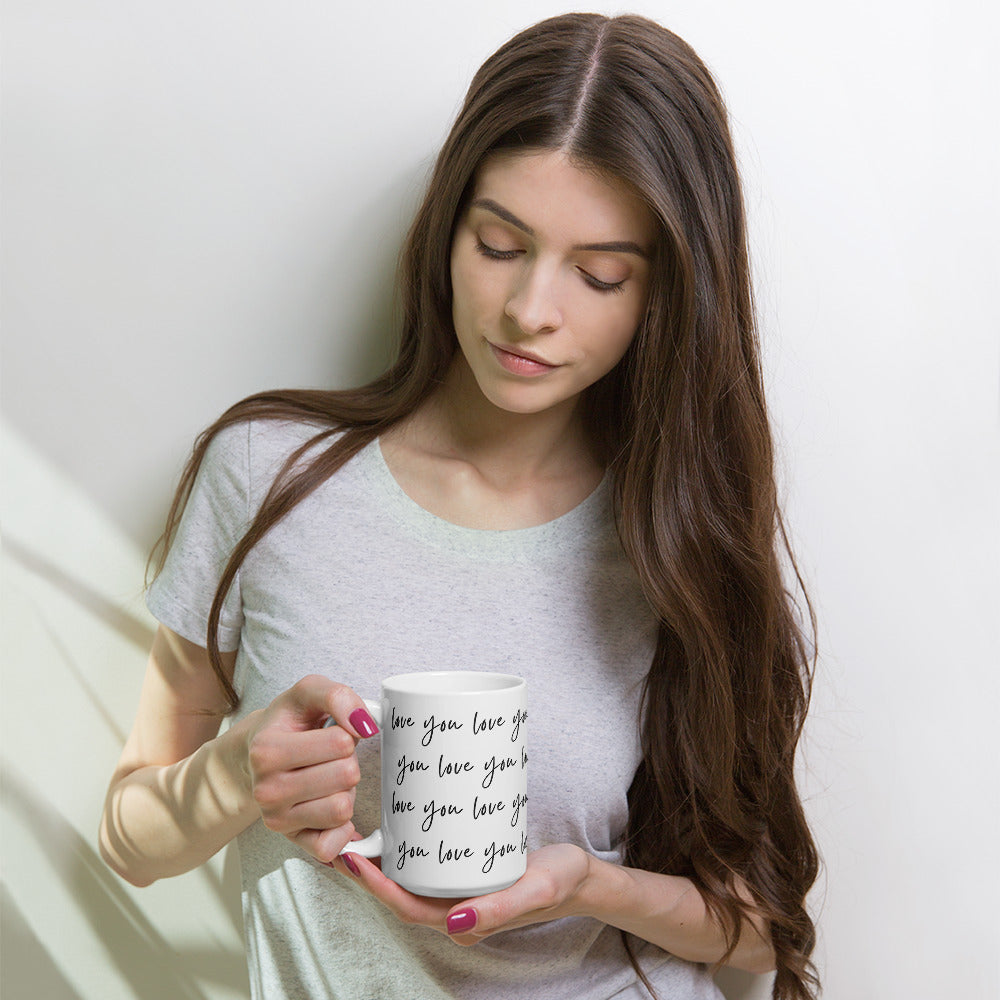 Woman enjoying coffee in her love you ceramic mug