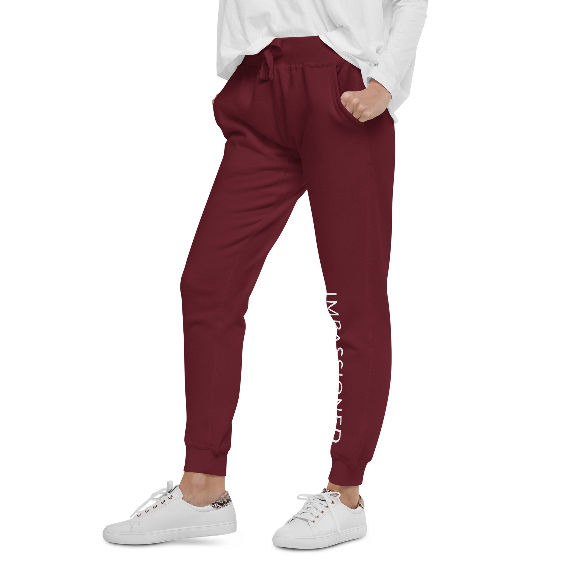 Fleece jogger sweatpants in maroon with Impassioned printed on front left leg shows off the model's inspiring look